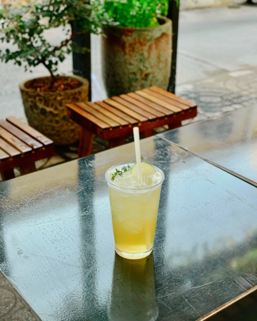 A glass of lemonade on an outdoor table at a garden party